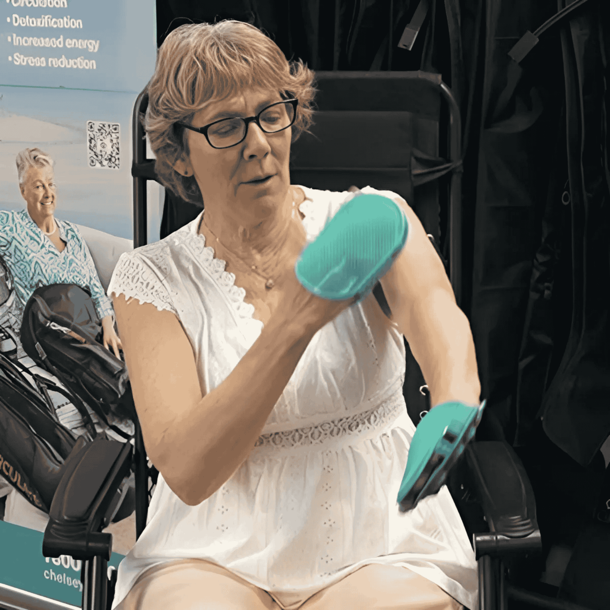 Woman in a chair using the dual action lymphatic gloves