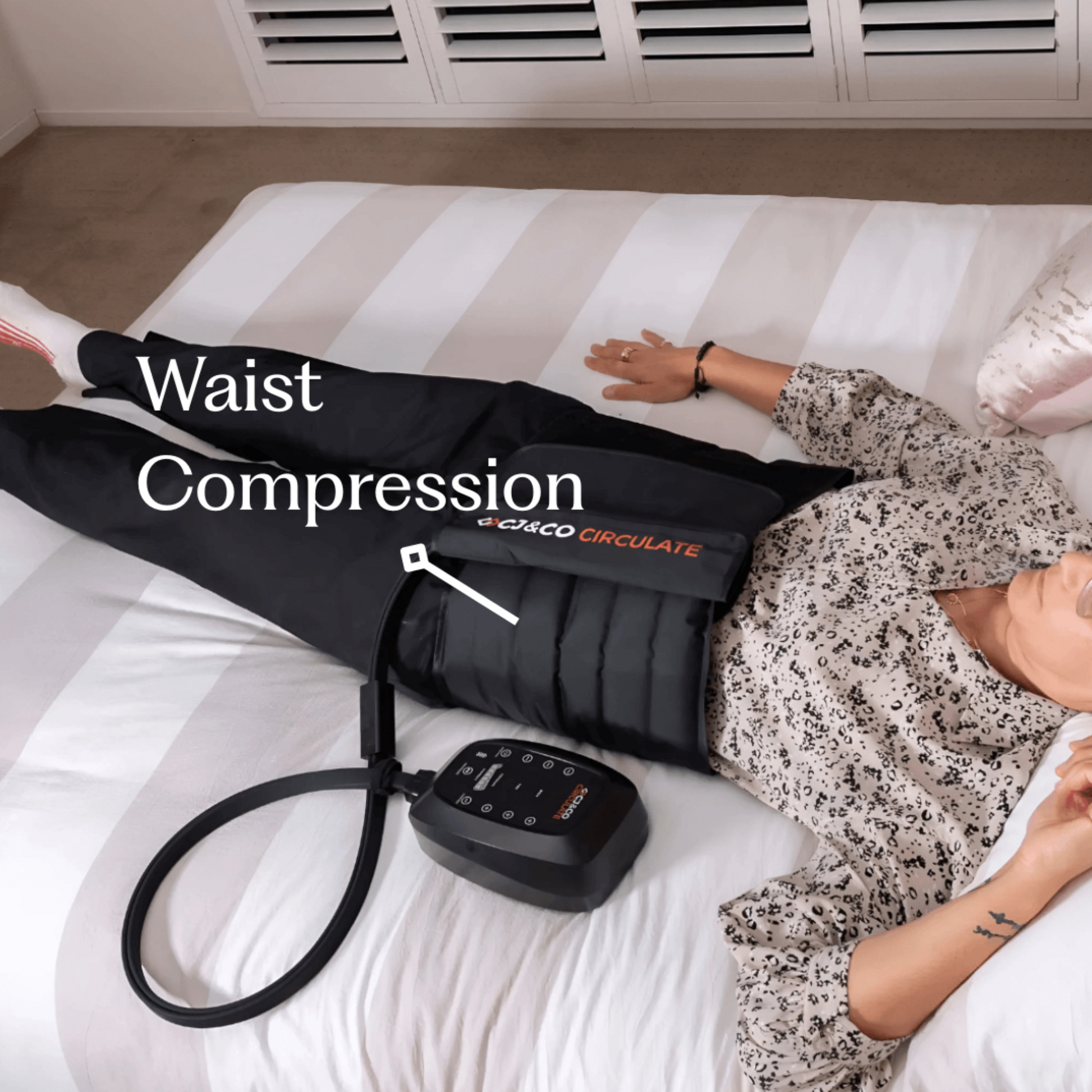 Person wearing a waist compression device on a bed with 'Circulate' branding.
